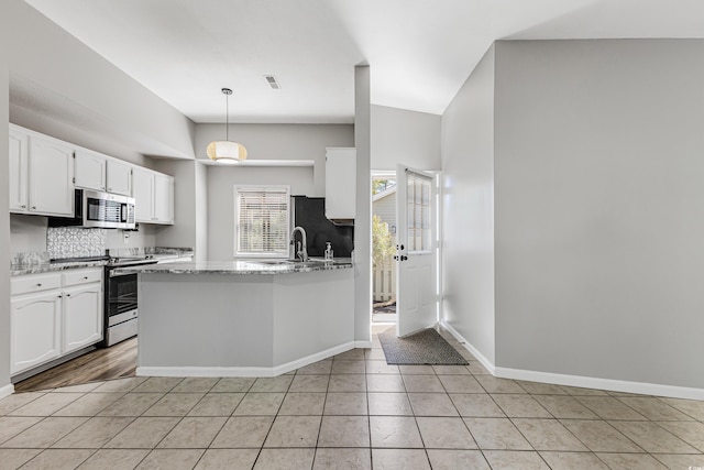 kitchen with white cabinetry, light stone countertops, light tile patterned flooring, pendant lighting, and stainless steel appliances