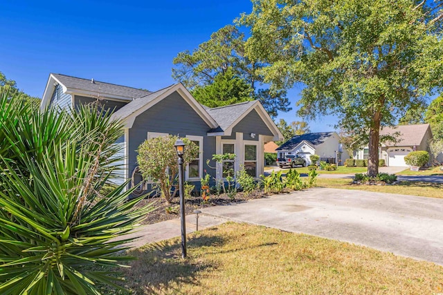 view of front of home with a garage and a front lawn