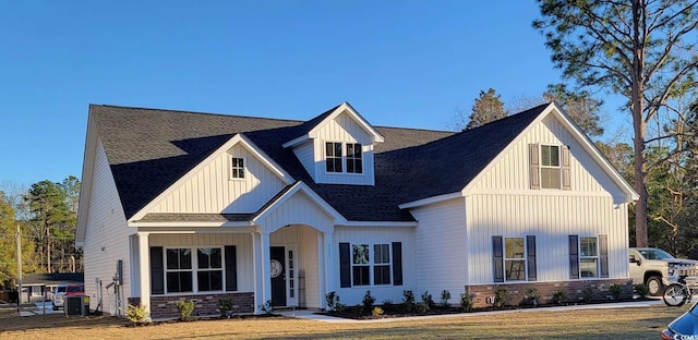 view of front of house featuring cooling unit and a front yard