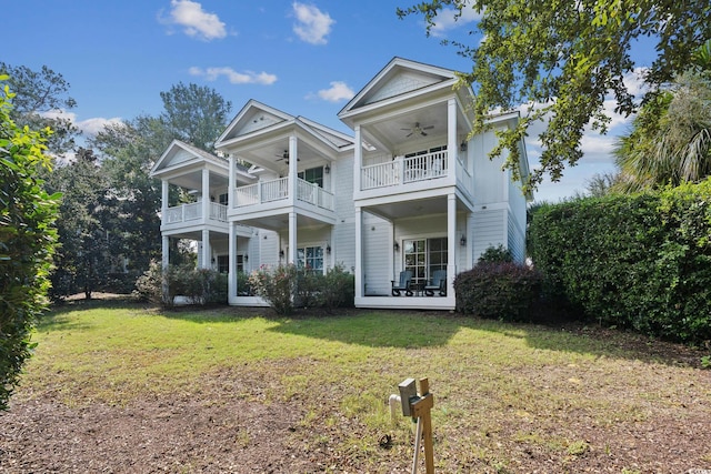 exterior space featuring a front lawn, ceiling fan, and a balcony