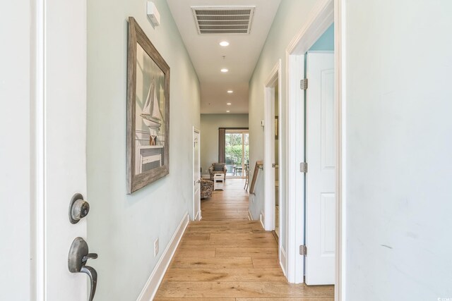 hallway with light hardwood / wood-style flooring