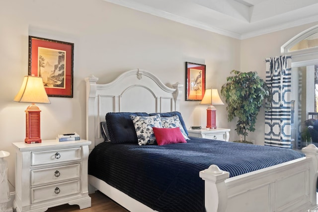 bedroom with ornamental molding and dark hardwood / wood-style floors