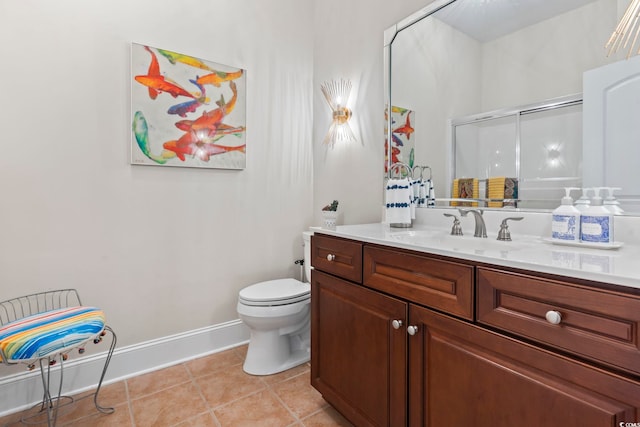 bathroom with vanity, tile patterned floors, toilet, and walk in shower