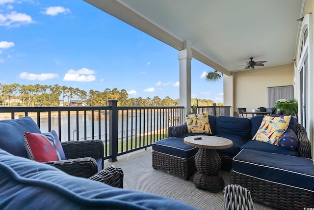 balcony with an outdoor living space, a water view, and ceiling fan