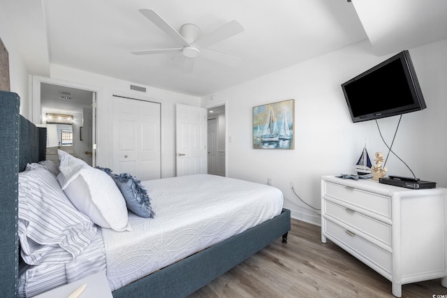 bedroom featuring a closet, ceiling fan, and light hardwood / wood-style flooring