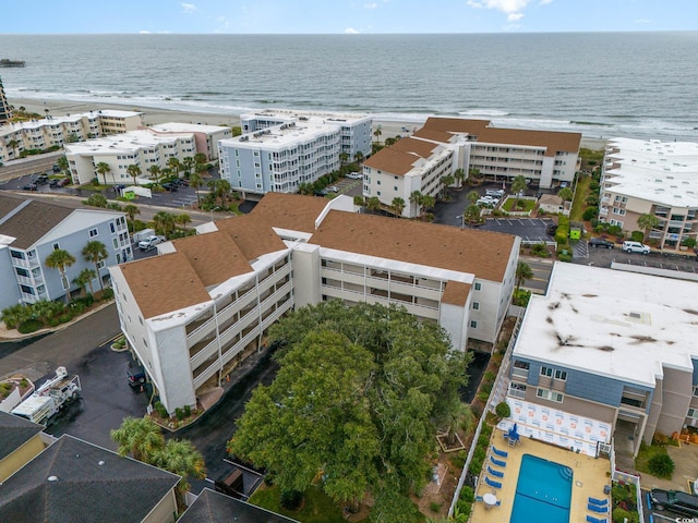 bird's eye view with a water view and a beach view