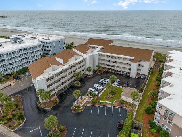 drone / aerial view featuring a water view and a view of the beach