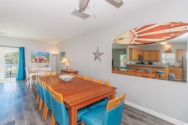 dining space featuring dark wood-type flooring, ceiling fan, and a wealth of natural light