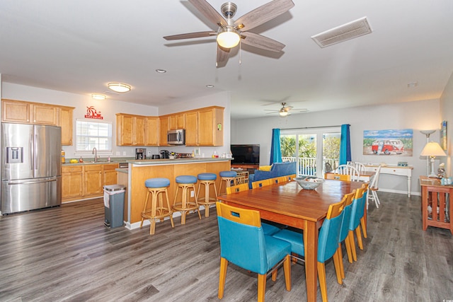 dining area featuring hardwood / wood-style flooring, sink, plenty of natural light, and ceiling fan