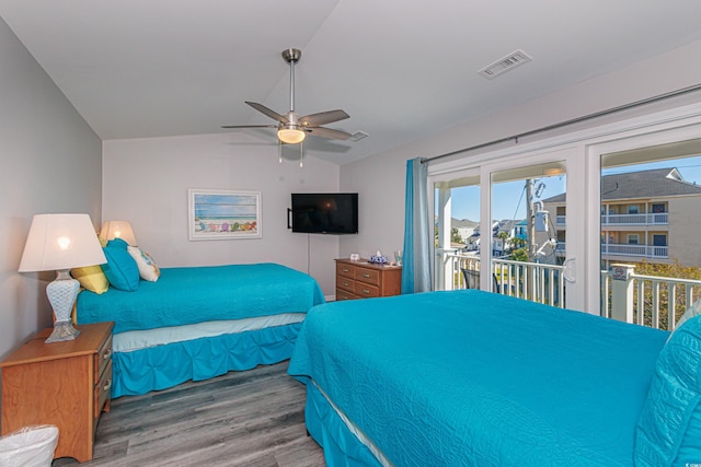 bedroom with ceiling fan, hardwood / wood-style flooring, vaulted ceiling, and access to exterior