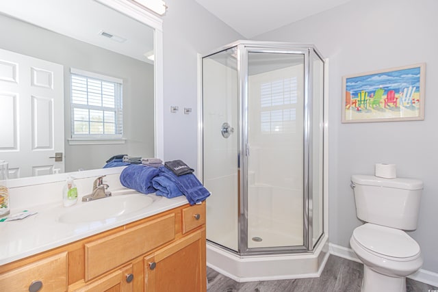 bathroom with vanity, an enclosed shower, hardwood / wood-style flooring, and toilet