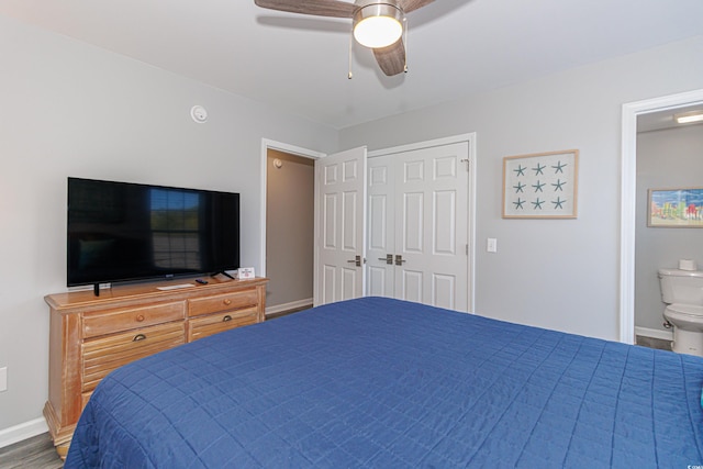 bedroom with hardwood / wood-style flooring, ensuite bathroom, a closet, and ceiling fan