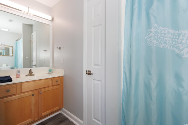 bathroom with vanity and hardwood / wood-style flooring