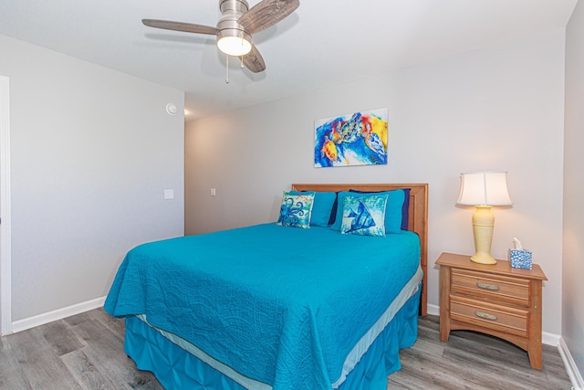 bedroom featuring ceiling fan and hardwood / wood-style flooring