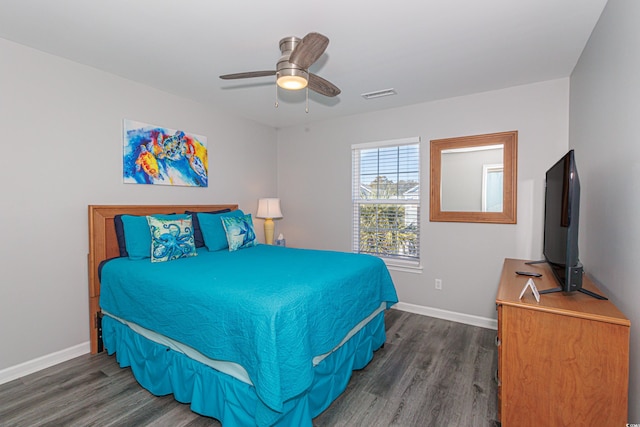 bedroom with ceiling fan and dark hardwood / wood-style flooring