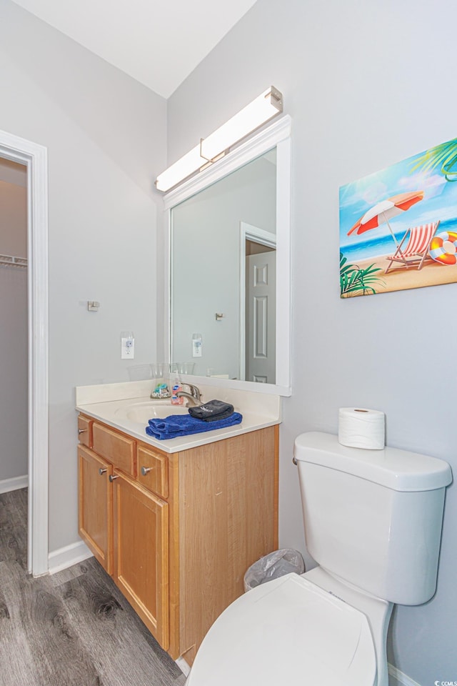 bathroom with vanity, hardwood / wood-style floors, and toilet