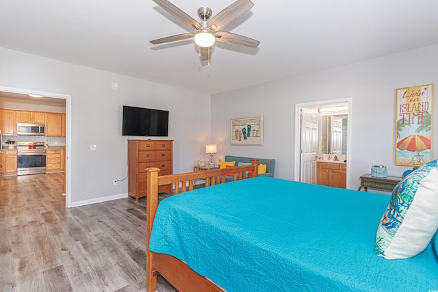 bedroom with light hardwood / wood-style flooring, ensuite bathroom, and ceiling fan