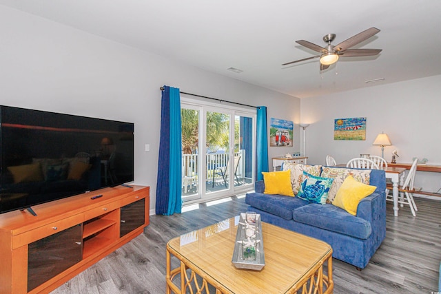 living room with ceiling fan and hardwood / wood-style flooring