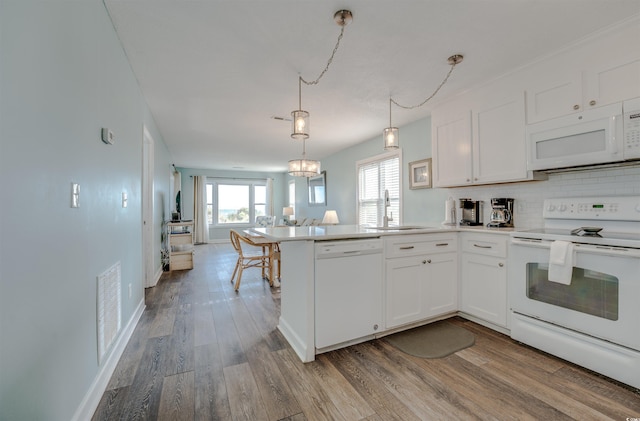 kitchen featuring sink, white cabinetry, white appliances, and light hardwood / wood-style floors