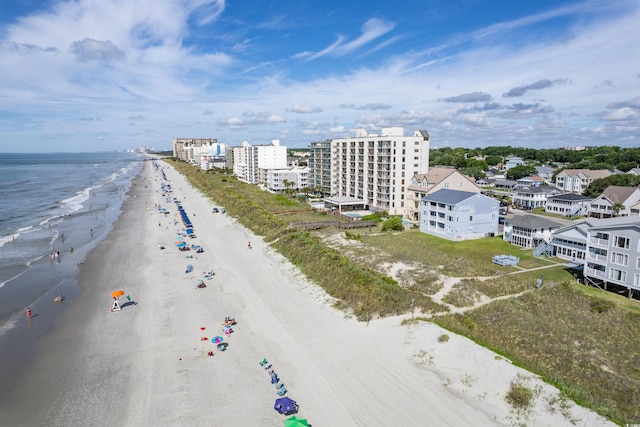 drone / aerial view featuring a water view and a beach view