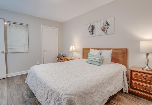 bedroom with dark wood-type flooring