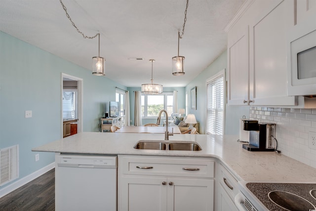 kitchen featuring white cabinets, hanging light fixtures, dark wood-type flooring, sink, and white appliances