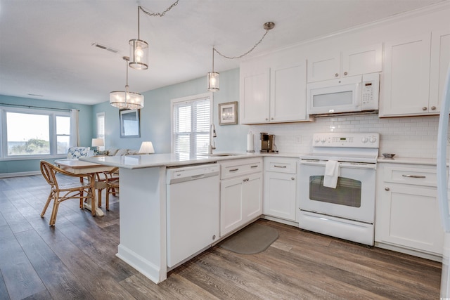 kitchen with a healthy amount of sunlight, white cabinetry, and white appliances