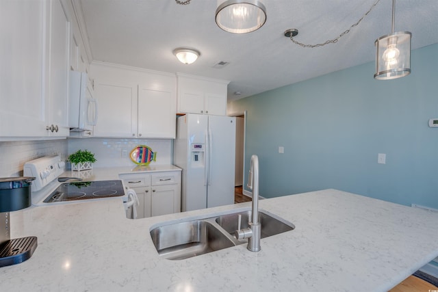 kitchen featuring white cabinets, sink, backsplash, and white appliances