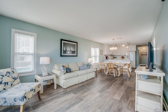 living room featuring a notable chandelier and wood-type flooring