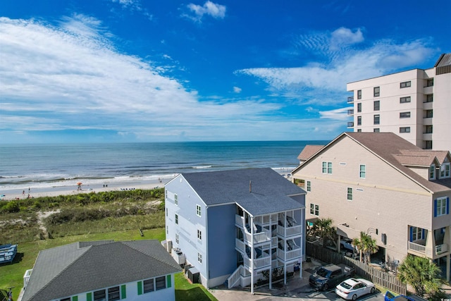 birds eye view of property featuring a water view and a beach view