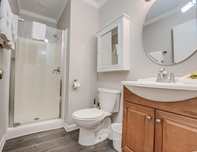 bathroom with hardwood / wood-style floors, toilet, crown molding, vanity, and an enclosed shower