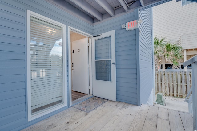 doorway to property featuring a wooden deck and fence