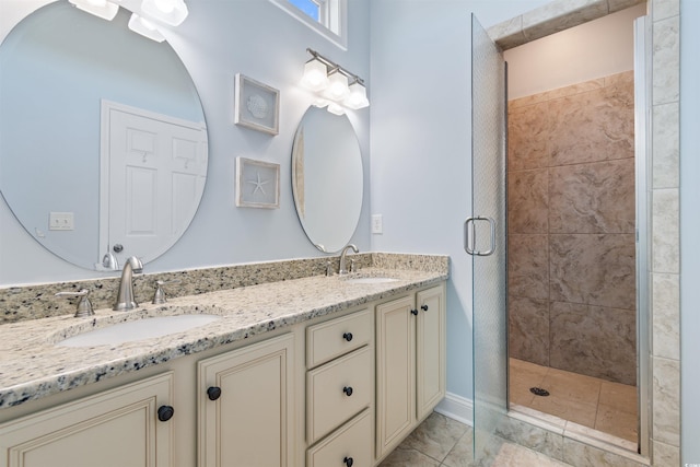 bathroom featuring a shower with door and vanity