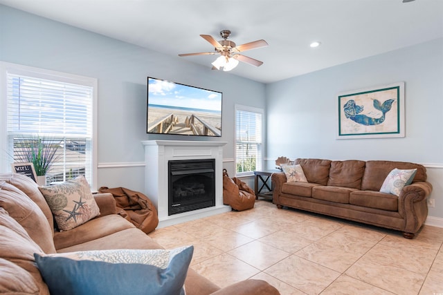 living room with ceiling fan and light tile patterned floors