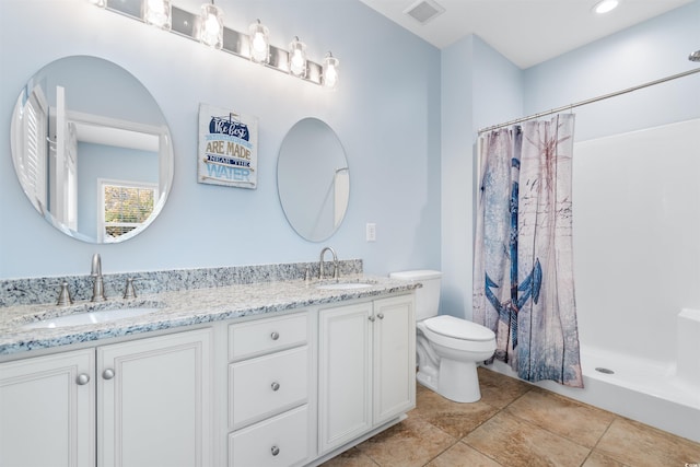 bathroom with vanity, toilet, tile patterned floors, and a shower with shower curtain