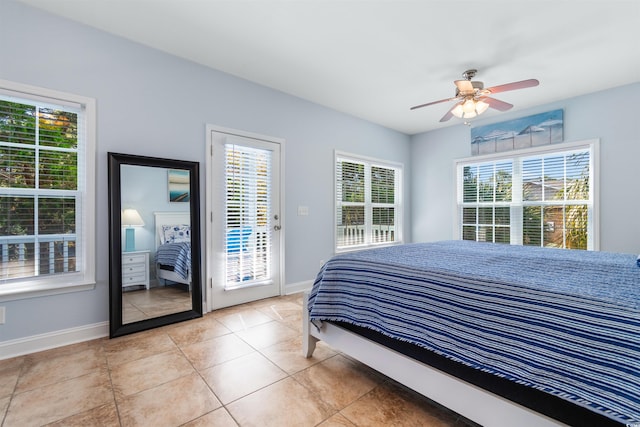 bedroom featuring access to outside, multiple windows, and ceiling fan