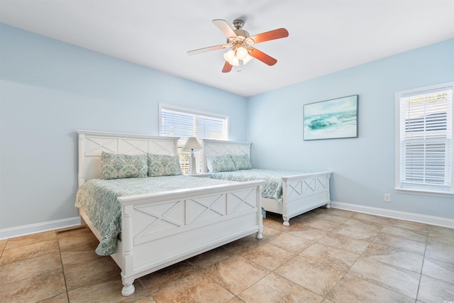 tiled bedroom with ceiling fan