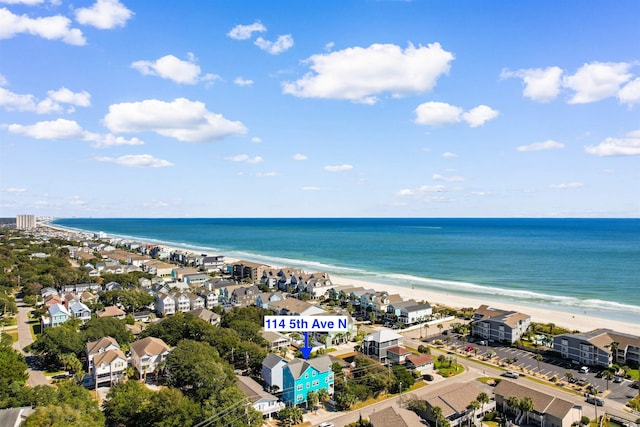 birds eye view of property with a water view and a beach view