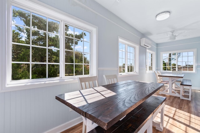 dining area with a wealth of natural light and hardwood / wood-style flooring