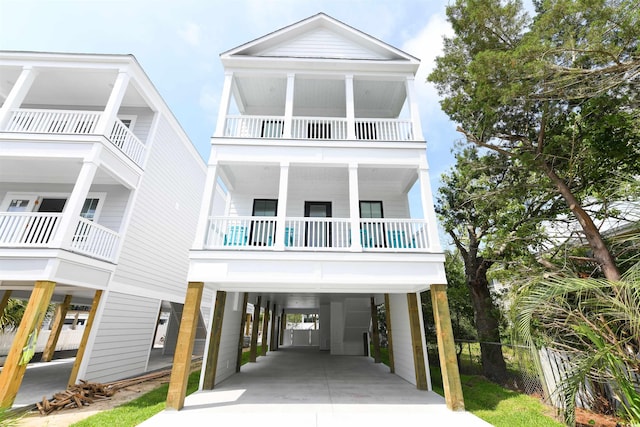 coastal inspired home featuring a carport and a balcony