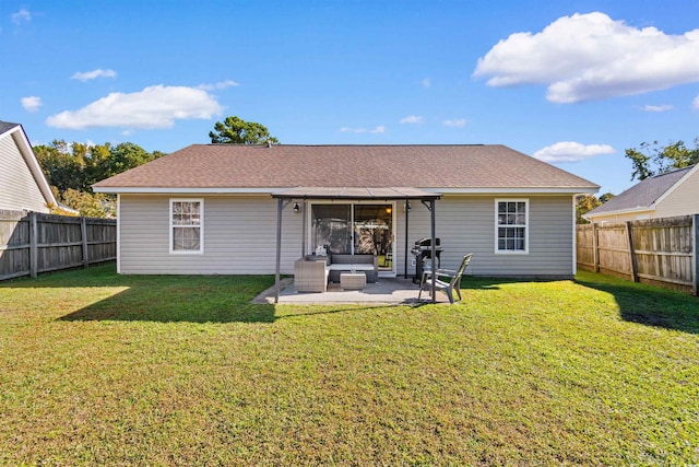 rear view of house with outdoor lounge area, a yard, and a patio