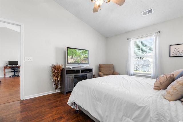 bedroom featuring dark hardwood / wood-style floors, vaulted ceiling, and ceiling fan