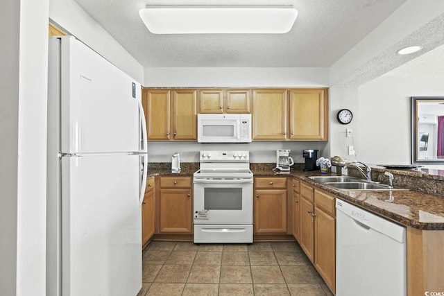 kitchen featuring white appliances, sink, a textured ceiling, kitchen peninsula, and light tile patterned floors