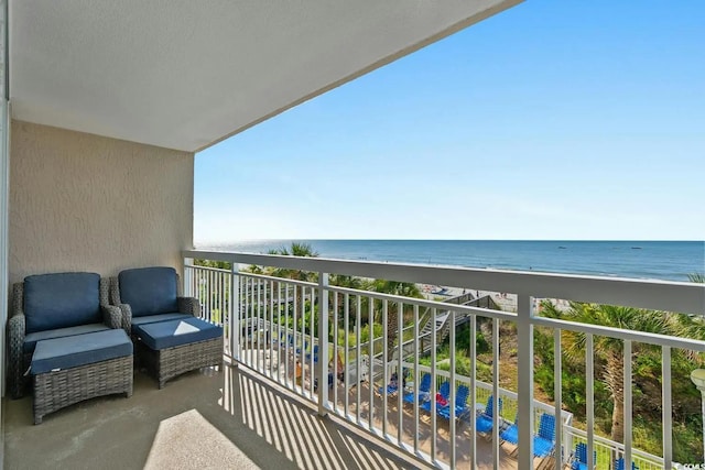 balcony featuring a water view and a beach view