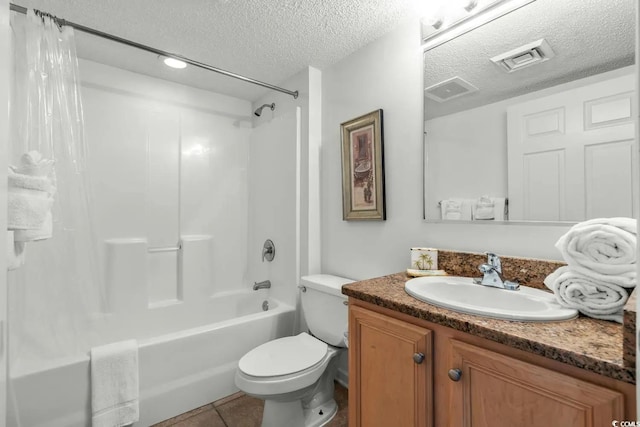 full bathroom with shower / tub combo, a textured ceiling, toilet, vanity, and tile patterned flooring