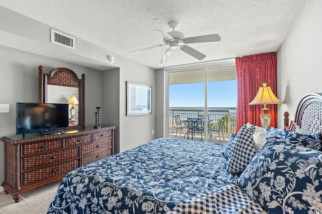 bedroom with carpet, a textured ceiling, access to outside, and ceiling fan