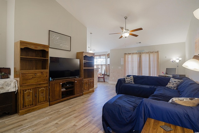 living room with ceiling fan, light hardwood / wood-style floors, and lofted ceiling