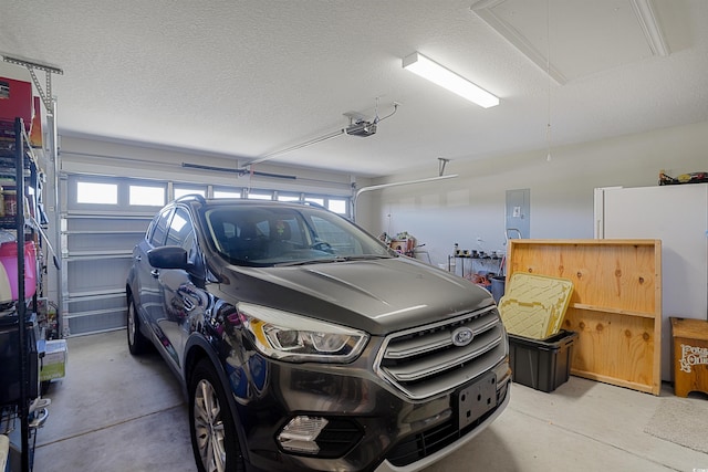 garage featuring electric panel and a garage door opener