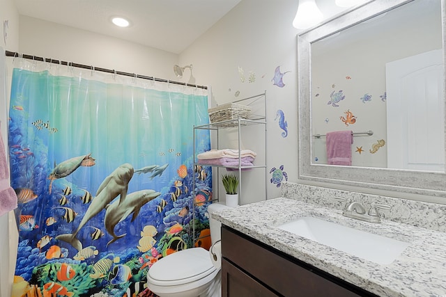 bathroom with curtained shower, vanity, and toilet