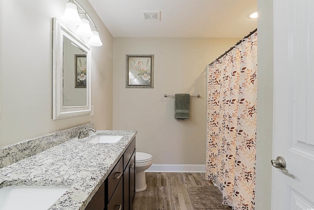 bathroom featuring a shower with curtain, vanity, toilet, and wood-type flooring